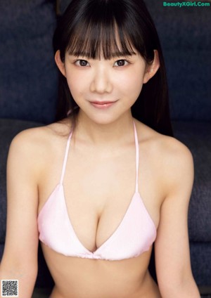 A woman in a pink bikini posing for a magazine.