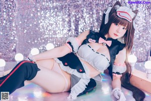 A woman in a maid outfit posing for a picture.