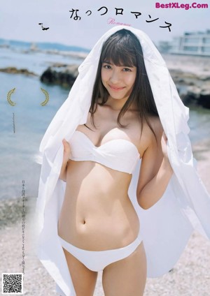 A woman in a white dress posing for a picture.