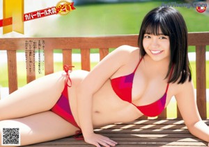 A woman in a red bikini sitting in the back of a truck.