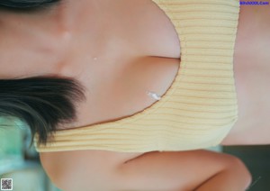 A woman in a pink lingerie sitting on a window sill.