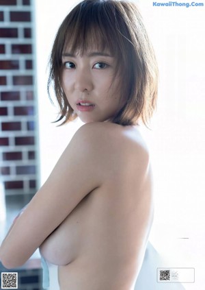 A woman in a blue lingerie posing for a picture.
