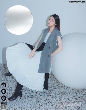 A woman in a pink dress on the cover of a magazine.