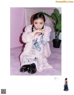 a magazine page with a woman wearing a necklace and a sweater