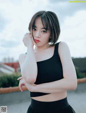 A woman in a white dress posing for a magazine cover.