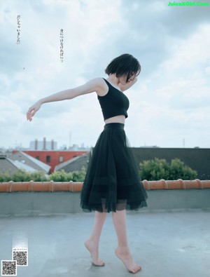 A woman in a white dress posing for a picture.